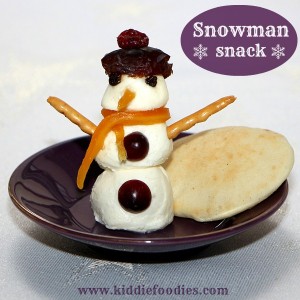 Snowman snack with mozzarella balls and dried fruits